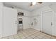 Spacious laundry room with tile flooring, shelving, and a door leading to the outside at 4425 Porpoise Dr, Tampa, FL 33617