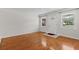 Bright living room featuring hardwood floors, and a white front door and white trim at 4425 Porpoise Dr, Tampa, FL 33617