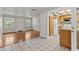 Bright living room featuring hardwood floors, neutral walls, and a view into the adjacent kitchen at 4425 Porpoise Dr, Tampa, FL 33617