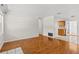 Bright living room with hardwood floors and neutral walls, leading to the kitchen at 4425 Porpoise Dr, Tampa, FL 33617