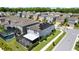 Aerial view of a modern home featuring solar panels, a screened pool and a backyard at 4679 Emprise Way, Land O Lakes, FL 34638