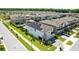 Aerial view of home with solar panels, lush landscaping, and manicured lawn at 4679 Emprise Way, Land O Lakes, FL 34638