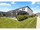 Spacious backyard featuring a screened-in patio and lush green lawn at 4679 Emprise Way, Land O Lakes, FL 34638