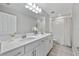 Bathroom with dual sinks, bright lighting, and a shower-tub combination for convenience at 4679 Emprise Way, Land O Lakes, FL 34638