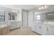 Bright bathroom with double vanities, large mirrors, and a soaking tub at 4679 Emprise Way, Land O Lakes, FL 34638