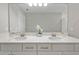 Bathroom featuring double sinks, a large mirror, and a clean, modern design at 4679 Emprise Way, Land O Lakes, FL 34638