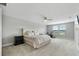 Spacious bedroom featuring plush carpeting, a modern ceiling fan, and bright natural light at 4679 Emprise Way, Land O Lakes, FL 34638