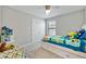 bedroom features a cozy bed with colorful toys and a built-in shelving unit at 4679 Emprise Way, Land O Lakes, FL 34638