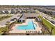 Inviting community pool with lounge chairs and shaded areas, perfect for relaxation and socializing in a picturesque setting at 4679 Emprise Way, Land O Lakes, FL 34638