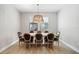 Dining room with wood floors, modern chandelier, and wooden table with eight upholstered chairs at 4679 Emprise Way, Land O Lakes, FL 34638