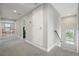 Upstairs hallway with carpet floors, neutral walls, and a view of the bedroom in the background at 4679 Emprise Way, Land O Lakes, FL 34638