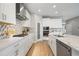 Well-appointed kitchen with stainless steel appliances, quartz countertops, white cabinets, and mosaic tile backsplash at 4679 Emprise Way, Land O Lakes, FL 34638