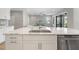 Bright kitchen boasts quartz countertops, stainless dishwasher, and an open design to the living space at 4679 Emprise Way, Land O Lakes, FL 34638