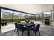 Relaxing screened lanai featuring a dining table, chairs, and a stainless steel grill at 4679 Emprise Way, Land O Lakes, FL 34638