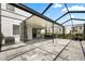 Spacious screened lanai perfect for outdoor dining and entertaining, features a patio and view of backyard at 4679 Emprise Way, Land O Lakes, FL 34638