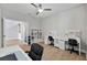 Office space with neutral walls, wood-look floors, ceiling fan, and a white desk and shelving at 4679 Emprise Way, Land O Lakes, FL 34638