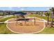 Community playground featuring swings, climbing structures, and picnic tables, perfect for Gathering fun at 4679 Emprise Way, Land O Lakes, FL 34638