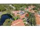 An aerial view of a lakeside community with lush trees and well-maintained lawns at 4783 Palermo Ne Ct # 4783, St Petersburg, FL 33703