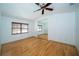Bright bedroom featuring wood floors and a large mirror, creating an open and airy feel at 4783 Palermo Ne Ct # 4783, St Petersburg, FL 33703