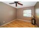 Cozy bedroom with hardwood floors, a ceiling fan, and a window providing natural light at 4783 Palermo Ne Ct # 4783, St Petersburg, FL 33703