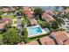 An aerial view of a sparkling community pool area with surrounding lounge chairs and well-manicured landscaping at 4783 Palermo Ne Ct # 4783, St Petersburg, FL 33703