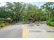 Gated entrance with lush landscaping and signage for visitor access at 4783 Palermo Ne Ct # 4783, St Petersburg, FL 33703
