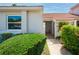 Inviting home featuring a secure gated entrance with lush landscaping and a red tile roof at 4783 Palermo Ne Ct # 4783, St Petersburg, FL 33703