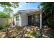Inviting front entrance with small rock garden and seating area for relaxing in the Florida sunshine at 4783 Palermo Ne Ct # 4783, St Petersburg, FL 33703