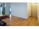 Open hallway with hardwood floors leading to various rooms in the home and featuring neutral wall colors at 4783 Palermo Ne Ct # 4783, St Petersburg, FL 33703