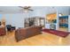 Inviting living room with hardwood floors, ceiling fan, and a view of the adjacent kitchen and sunroom at 4783 Palermo Ne Ct # 4783, St Petersburg, FL 33703