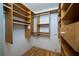 Spacious walk-in closet with custom wooden shelving and ample storage space at 4783 Palermo Ne Ct # 4783, St Petersburg, FL 33703