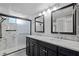 Bathroom features a double sink vanity, dual mirrors, and a tiled glass shower at 4851 W Gandy Blvd # B1L8, Tampa, FL 33611