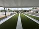 This is a view of the covered bocce ball court with the Canadian and U.S. Flags in the background at 4851 W Gandy Blvd # B1L8, Tampa, FL 33611
