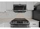 Close up of modern stainless steel oven and microwave with beautiful white countertops at 4851 W Gandy Blvd # B1L8, Tampa, FL 33611