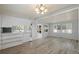 Open-concept living area with updated flooring, seamlessly connecting living and kitchen at 4851 W Gandy Blvd # B1L8, Tampa, FL 33611