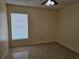 Empty bedroom with tile floors, window, and ceiling fan at 505 Innergary Pl, Valrico, FL 33594
