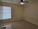 Bedroom featuring a ceiling fan, window, and tile flooring at 505 Innergary Pl, Valrico, FL 33594