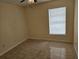 Bedroom featuring a window, ceiling fan, and tile flooring at 505 Innergary Pl, Valrico, FL 33594