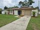 Charming single-story home with a well-manicured lawn, a neutral color palette, and attached garage at 505 Innergary Pl, Valrico, FL 33594