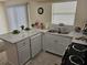 Bright kitchen featuring a kitchen island, white cabinetry and a stainless steel sink at 505 Innergary Pl, Valrico, FL 33594