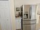 Modern stainless steel refrigerator complements the white cabinetry in the kitchen at 505 Innergary Pl, Valrico, FL 33594