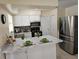 Bright kitchen features white cabinetry, stainless steel appliances, and a stylish backsplash at 505 Innergary Pl, Valrico, FL 33594