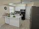 Bright kitchen features white cabinetry, stainless steel appliances, and a stylish backsplash at 505 Innergary Pl, Valrico, FL 33594