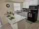 Bright kitchen features white cabinetry, stainless steel appliances, and stylish countertops at 505 Innergary Pl, Valrico, FL 33594