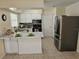 Bright kitchen features white cabinetry, stainless steel appliances, and a stylish backsplash at 505 Innergary Pl, Valrico, FL 33594