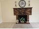 Cozy living room showcases a classic brick fireplace and neutral-toned decor at 505 Innergary Pl, Valrico, FL 33594