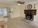 Bright living room with tile floors, fireplace, and view into kitchen at 505 Innergary Pl, Valrico, FL 33594