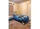 Cozy bedroom featuring a comfortable bed, soft carpet, natural light, and a closet for ample storage at 5351 Leisure Ln, New Port Richey, FL 34652