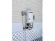 Exterior shot showcasing the wall-mounted Rinnai water heater and plumbing at 5351 Leisure Ln, New Port Richey, FL 34652