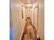 Hallway showcasing wood look vinyl flooring with white doors that bring a seamless flow to the interior at 5351 Leisure Ln, New Port Richey, FL 34652